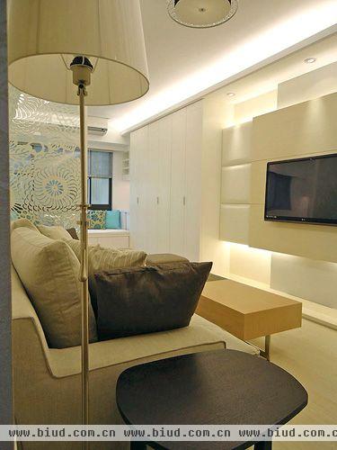 地板使用超耐磨木地板，并精心搭配柔和茶镜、立灯、沙发款式以及皮革材质的电视墙，为单人居住的家营造出温馨气氛。
