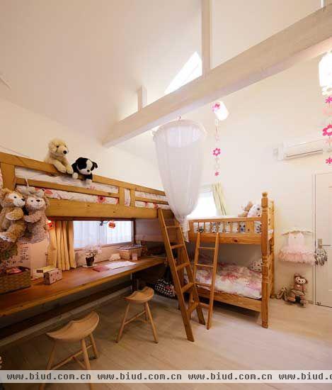 孩子们的房间选用纯手工的木质家居，清新又利于健康。床铺下方的空间用木板打造成学习空间，节省空间又方便整理。悬挂在房梁上的装饰挂件，相间的颜色搭配显得整个房间温馨可爱，无形间在视觉上延伸了房间的高度。粉色系的床品与可爱的玩偶一起，为孩子们营造出一个轻松，愉快的生活空间。