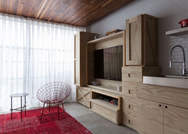 位于巴西圣保罗的这幢36㎡小公寓由建筑设计师Alan Chu设计完成，公寓分上下两层，圆形旋转楼梯相连。楼下是客厅、餐厅和厨房，由于面积局限没有墙体分割，一排箱子元素堆砌的柜子作为电视柜、橱柜和储藏柜。客厅沙发则是最为实用的沙发床，有客人的时候也可以作为卧室实用。走上旋转楼梯，二楼是卧室和一个卫生间。房子的主人透出忠于复古的情节，白色的地铁砖，复古的红色SMEG（斯麦格）冰箱，挂式老电话机…让整个家更加有味。