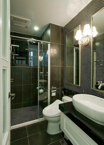 卫浴，饰以蜂巢状的磁砖，搭配对称的镜面与壁灯，散发内敛的华丽感。