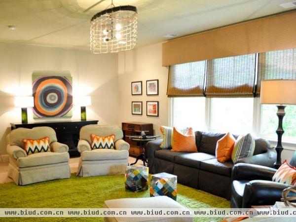  进入客厅，首先进入眼帘的是他五颜六色的色彩，绿色的地毯，橙色的抱枕，灰色的座椅，可以想象屋主是个很有个性的人，宽大的窗户增加空间的采光。
