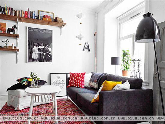 美丽时尚的客厅，白色的地板，高大明亮的窗户，经典的黑白条纹壁纸，不经意出现的红色软搭，让整个公寓既充满现代时尚酷感，又不乏明快清新之意。