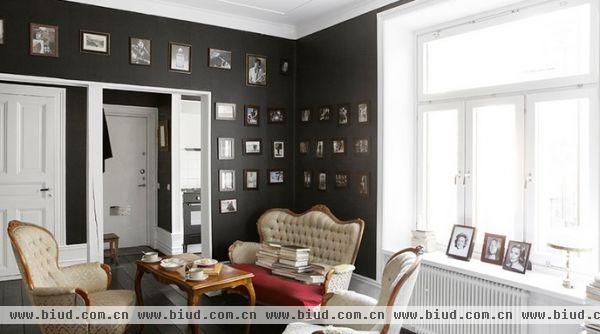 墙面漆上大面积的黑，搭配黑色的木地板，但保留天花板的白，透过白色门片与门窗，让空间不因黑色而显得压迫狭窄。在墙壁挂上照片，不只记录生活点滴，也是很具风格的装饰。
