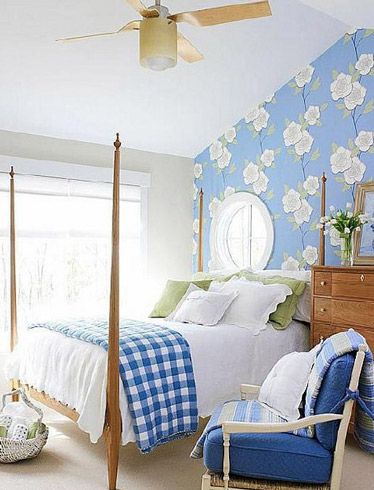 卧室里用蓝白色的格子床单凸显地中海风格的元素，天花板上的吊扇有种复古的风格，宽敞明亮的卧室内显得很洁净。