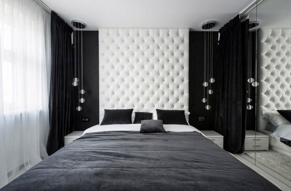 床头两边悬挂着参差不齐的球形白色水晶饰品，漂亮极了，床的一侧还设有一面镜子感觉整个房间给人通透的视觉效果，白色的吊灯对应着黑色的被褥，与整体的装修风格相协调。