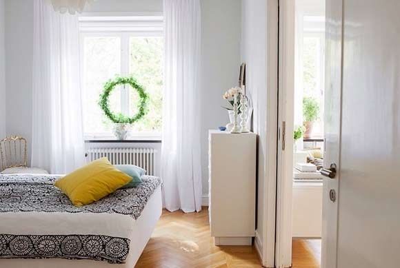 四百落地的卧室用的是原色实木地板，漂亮的原型树叶花环挂在窗户上，夏天待在这样的房间里真实凉爽至极。
