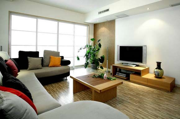 弧形墙面造型配上灰白得布艺沙发，在客厅空间成为一道风景线，简洁但不显简单电视墙，休闲的客厅配上休闲的沙发和家具一切都显得那么悠然自在。
