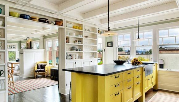 半开放式的厨房，采光效果很好，厨房里的杯杯盘盘变成了家中最美的装饰，很特别的黄色吧台可以当餐桌用。