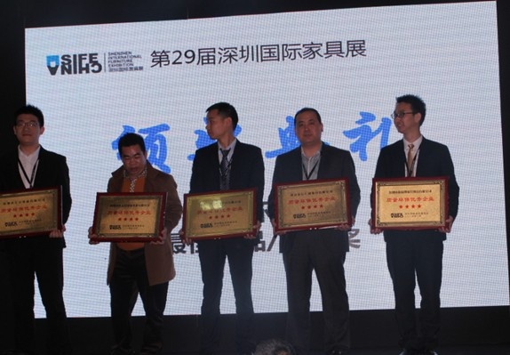 图为：伊丽伯特总裁王书通(右二)亲自上台领取质量环保五星级优秀企业奖牌