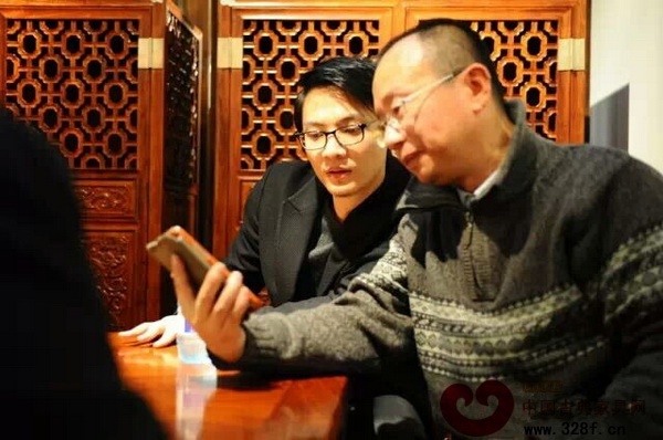 林锐群（左）与故宫博物院宫廷部副研究员周京南探讨珐琅工艺 